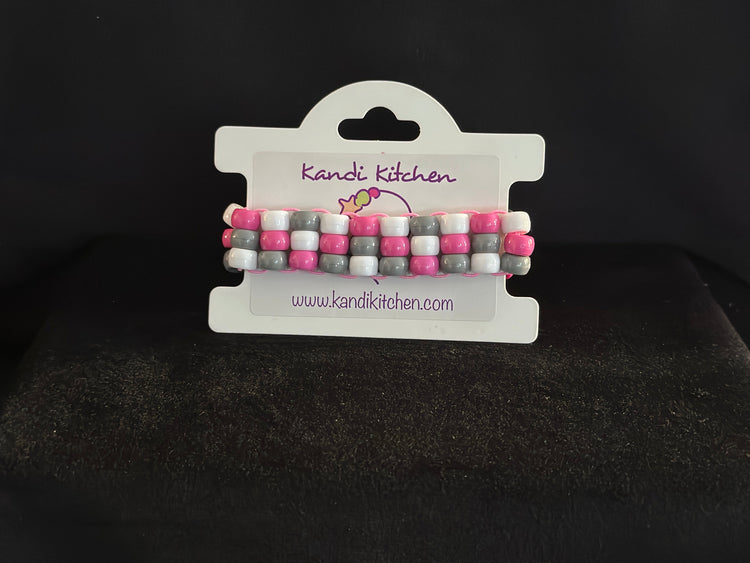 Ladder cuff with alternating colors of yellow, pink and white Kandi beads.